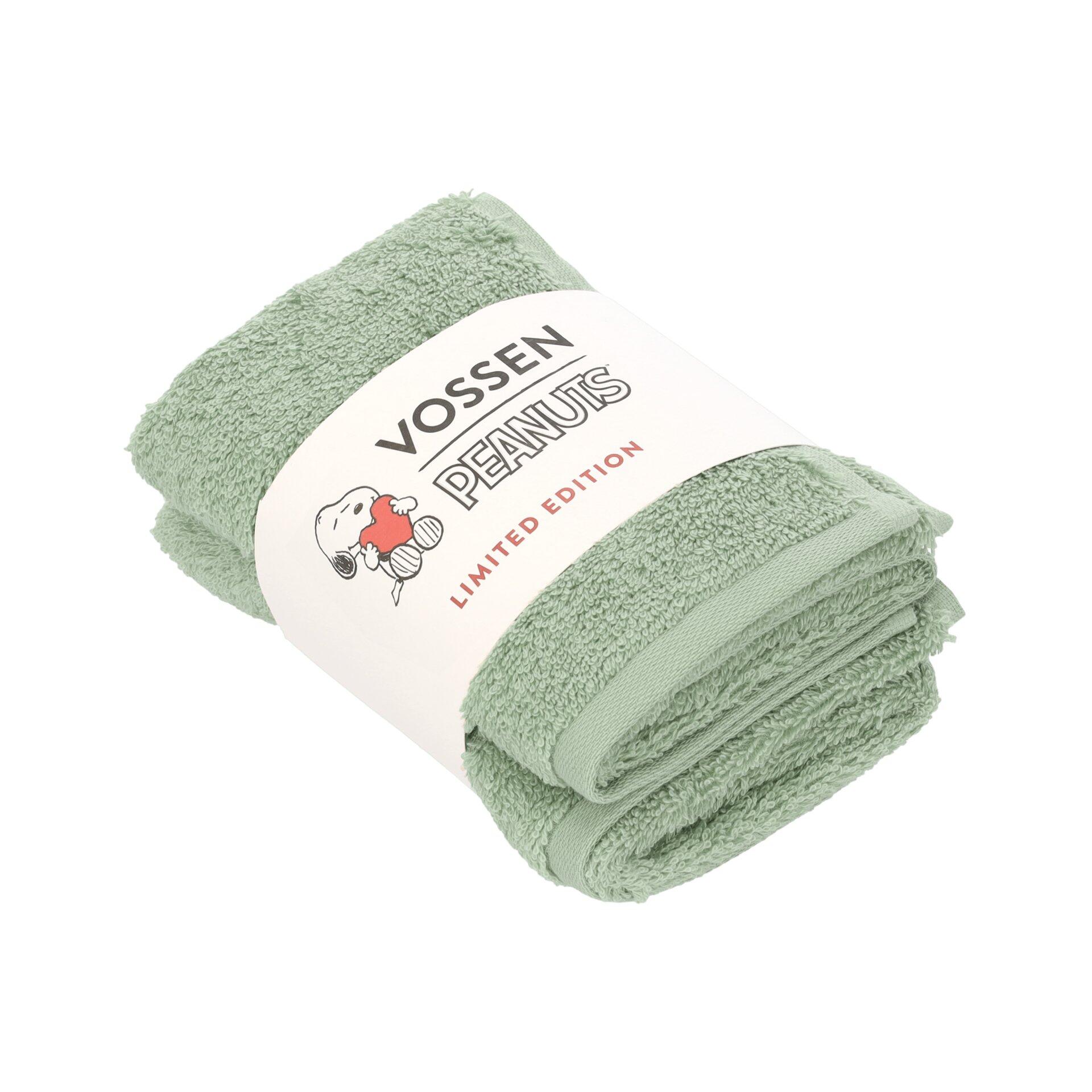 Frottierset Vossen in limitierter Peanuts Edition: Detailaufnahme eines hellgrünen, gefalteten Handtuchs in Kartonbandage mit Snoopy-Motiv.